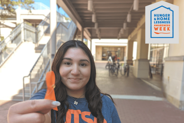 student with orange ribbon