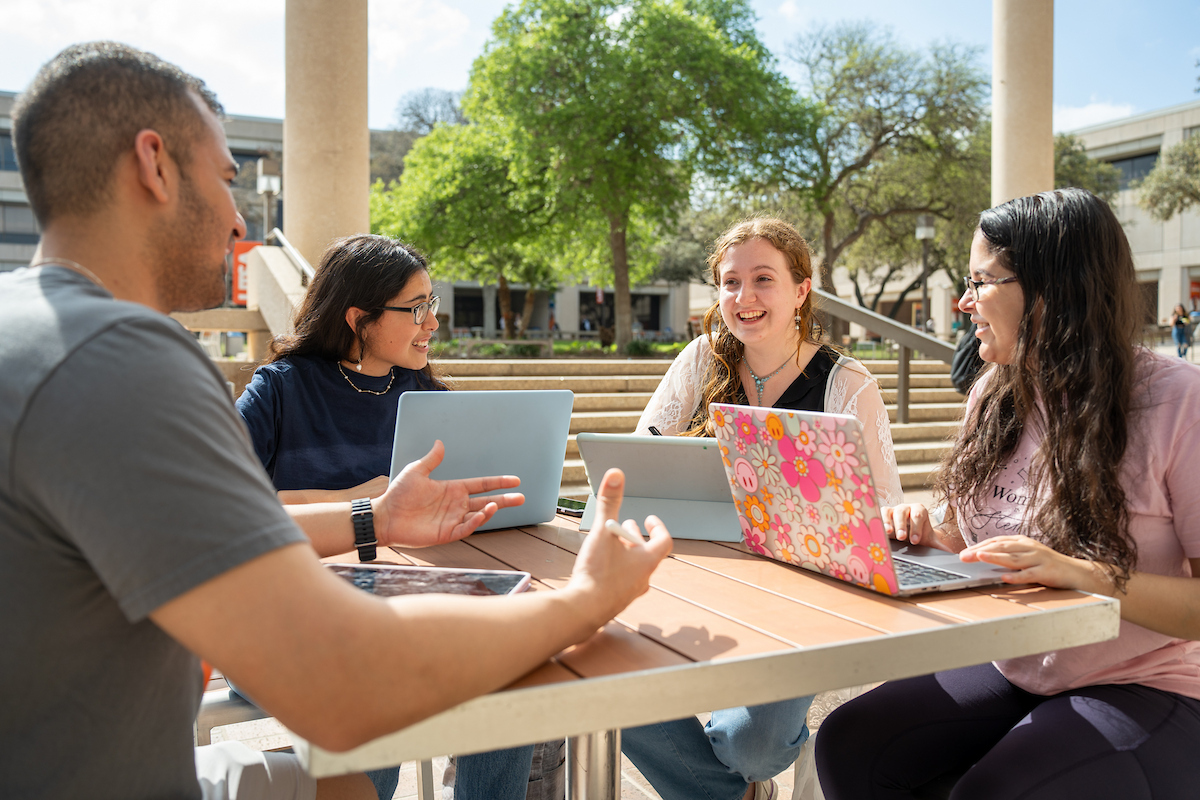 Students talking at Sombrilla Plaza