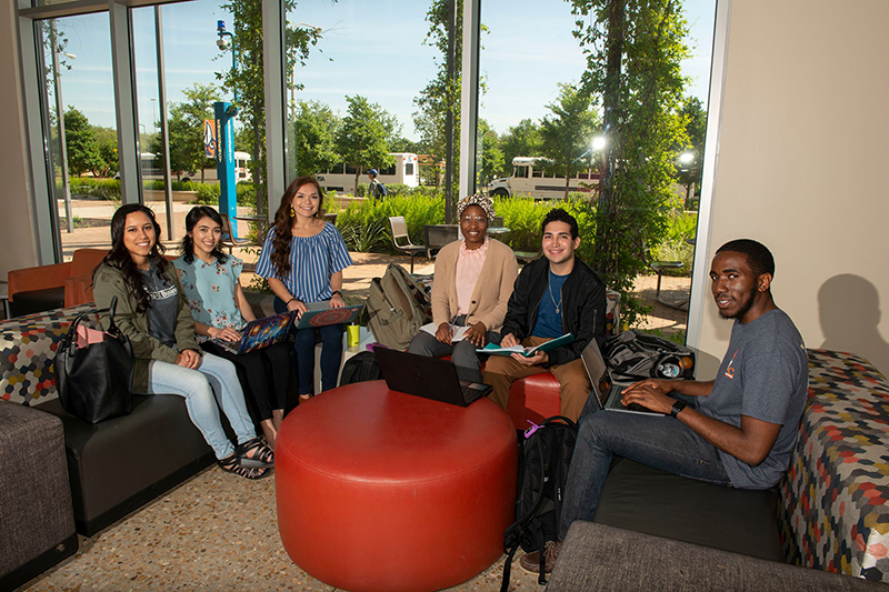 Students smiling in North Paseo building