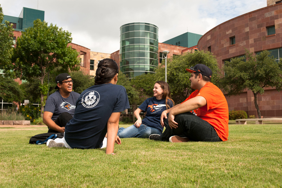 students sitting in the grass