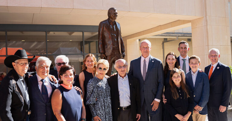 University leaders gathered with Harvey Najim and the Alvarez family for a group photo near the brand-new bronze statue