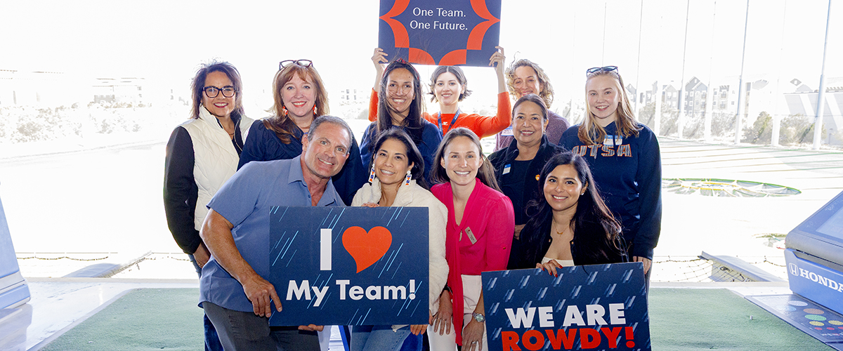 Advancement and Alumni Division empoyees at top golf smiling