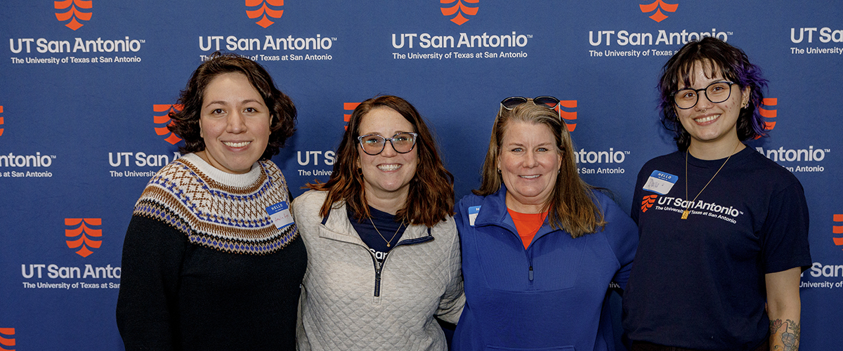 Team smiling in at top golf