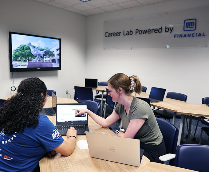 Students at GM career lab on campus working on laptop