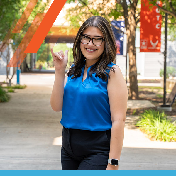 Anna Almaraz on UTSA campus giving birds up
