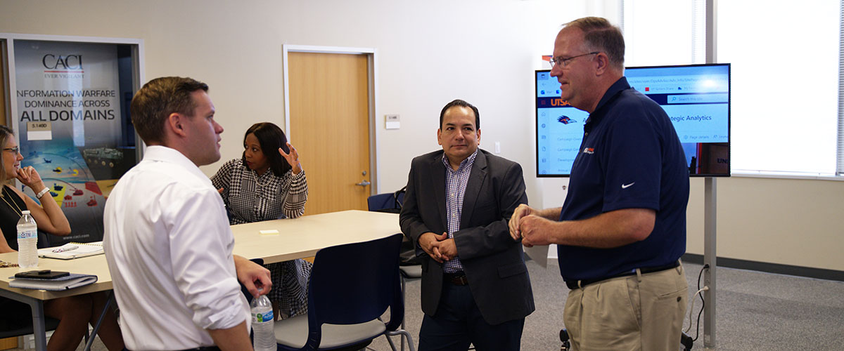 Team members chatting before meeting