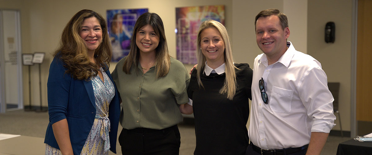 Advancement and Alumni Division empoyees at meeting smiling
