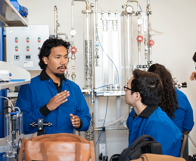 Professor teaching students in science lab