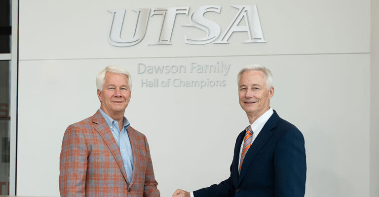 Sam and Gene Dawson in front of RACE Building