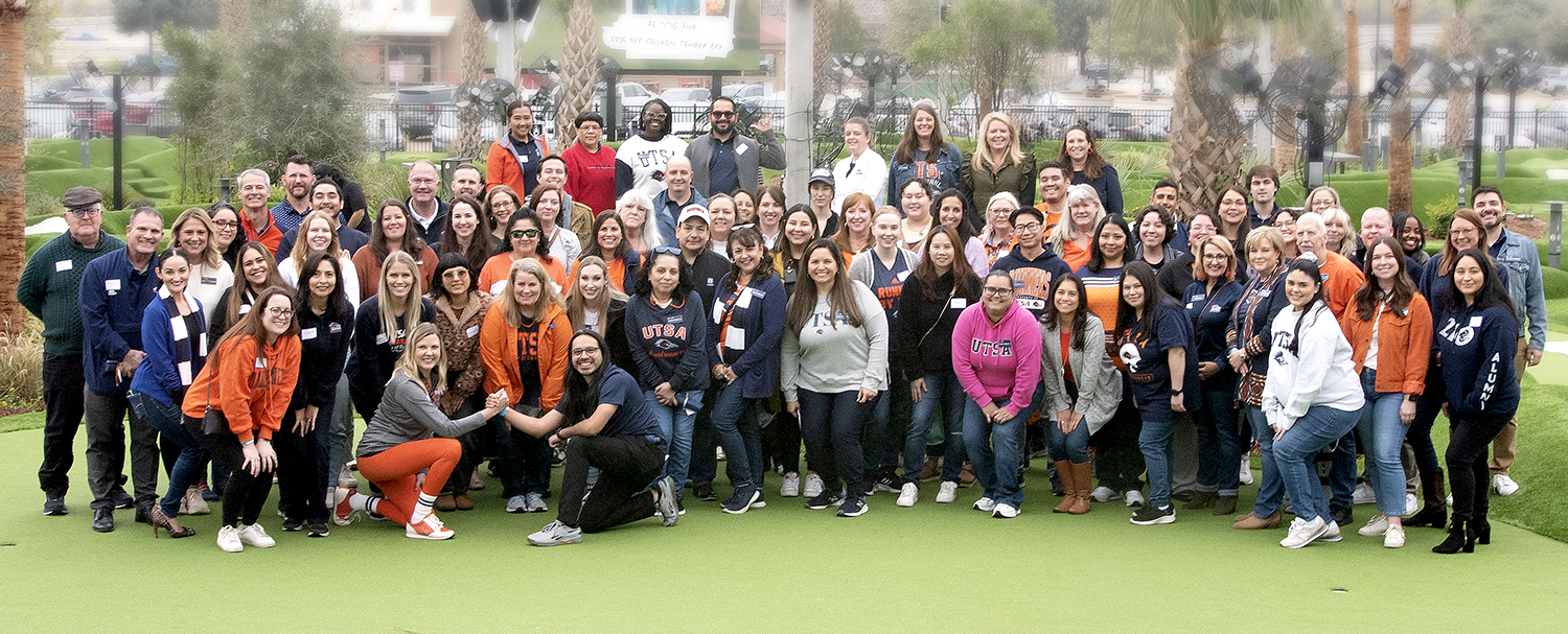 Alumni and advancement team posing at mini golf location