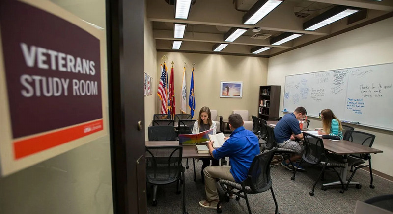 Students read through materials in the Veterans Study Room at the John Peace Library, home to the university's Center for Military Affiliated Students