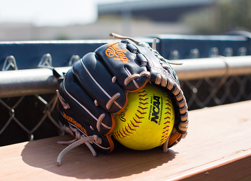 UT San Antonio softball ball and glove on bench
