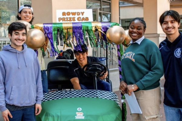 Students in a golf cart getting ready to ride and hand out prizes