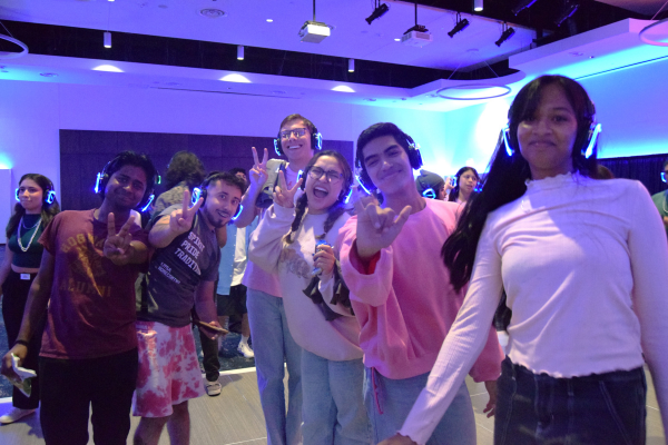 students dancing with glow in the dark headphones on
