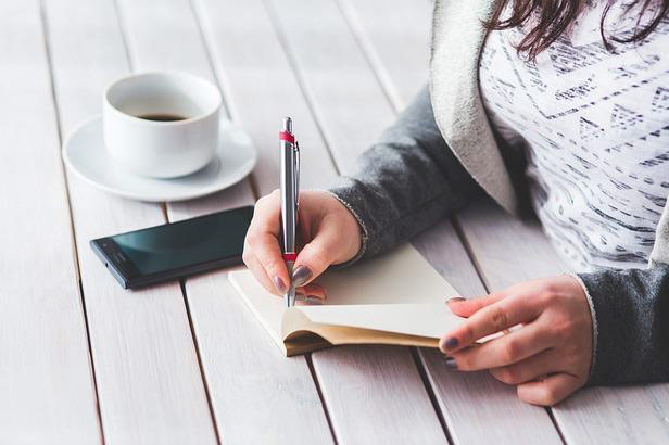 Student writing in notebook