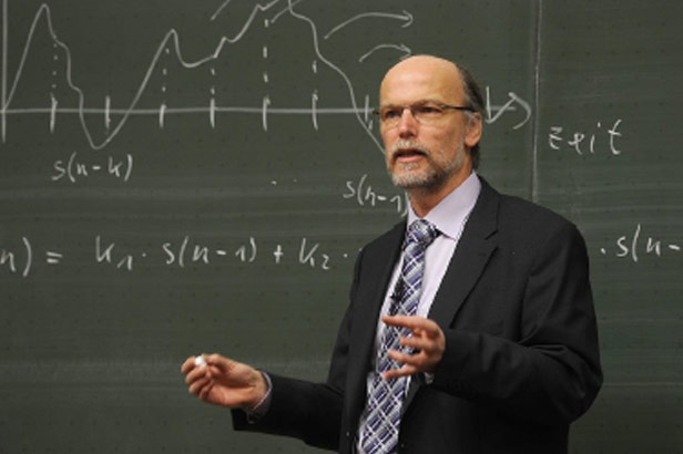 Law Professor lecturing in front of blackboard