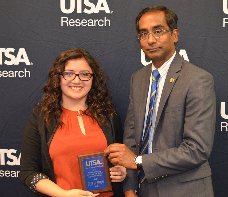Biomedical engineering student Grecia Gonzalez receives her award from Interim Vice President for Research Bernard Arulanandam.