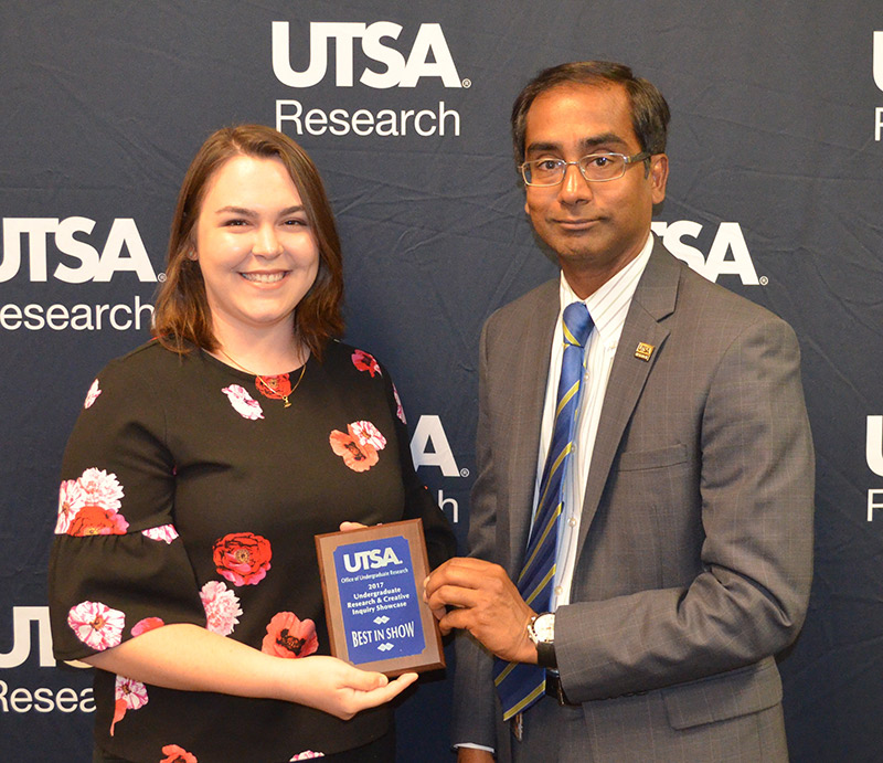 Mechanical engineering student Stephanie Meier receives her award from Interim Vice President for Research Bernard Arulanandam.