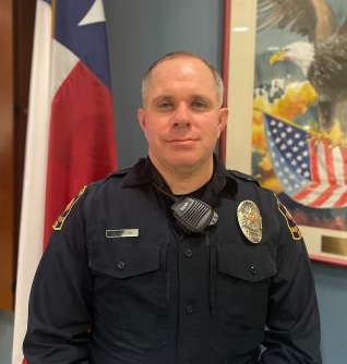 Charles Speck posing where black officer uniform.