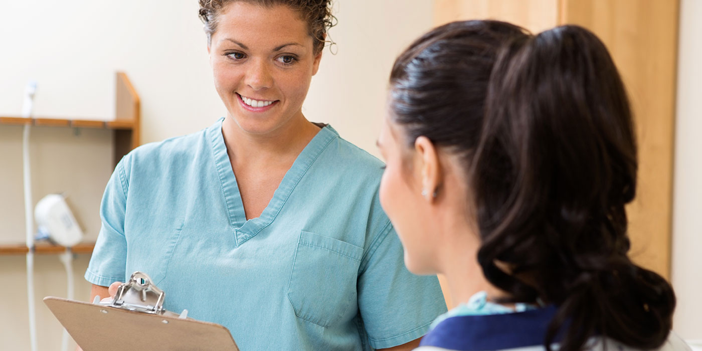 Medical assistant supporting a patient during a clinical visit