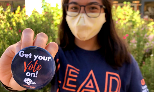 Student holding a Get your Vote on button