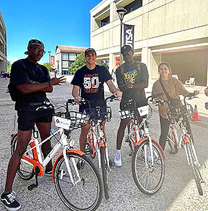 Students posing on bikes
