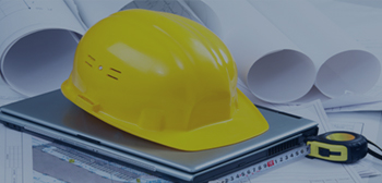 Hard hat on top of a laptop photo