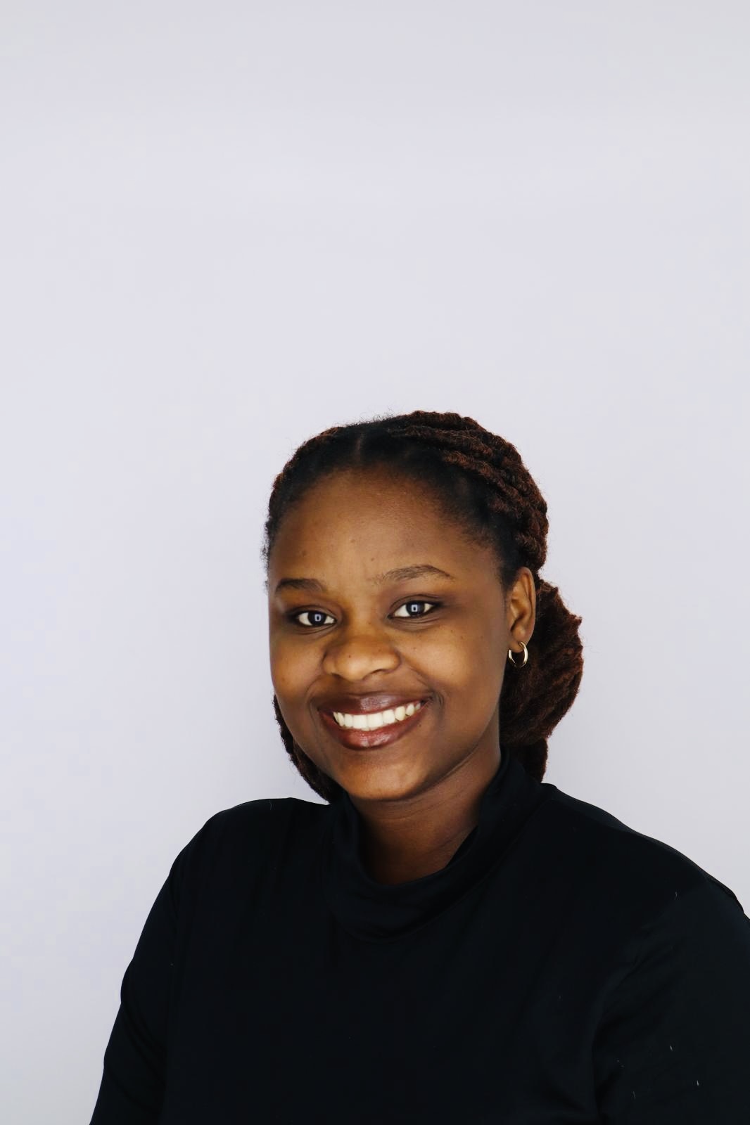 Clarisse Iradukunda professional head shot photo with a grey background