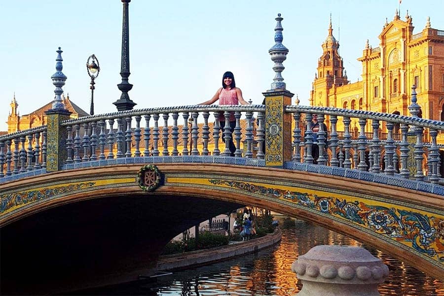 Salma Gomez '16 stands on one of the four bridges crossing over the canal at Plaza España in Seville, Spain. The bridges were erected to represent the four ancient kingdoms of Spain.