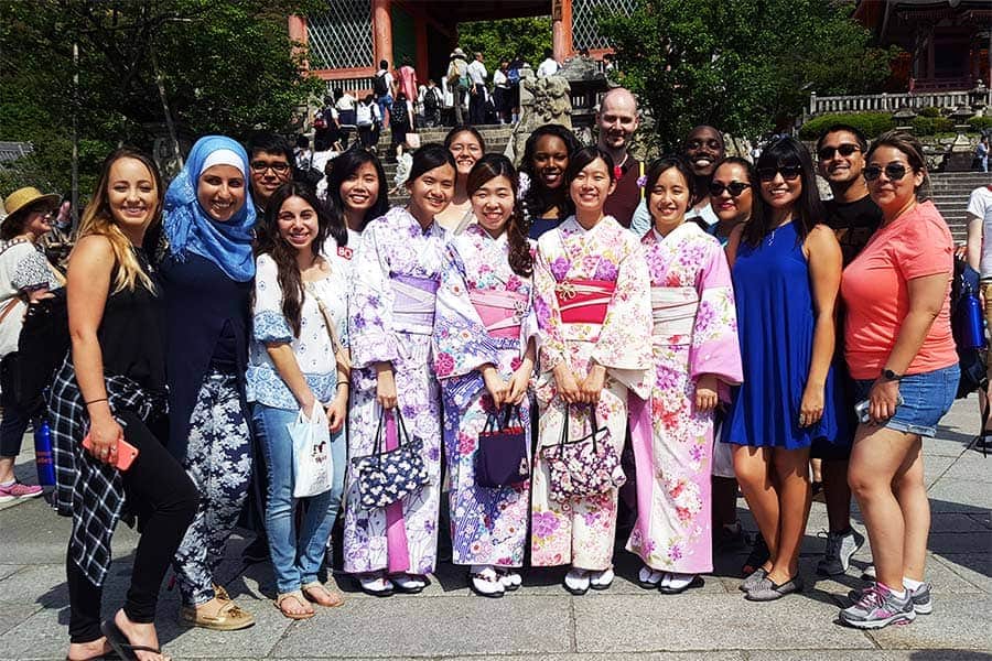 Salma Mendez Gomez '16 [in blue dress] poses with other UTSA students in Japan during one of her five study abroad excursions.