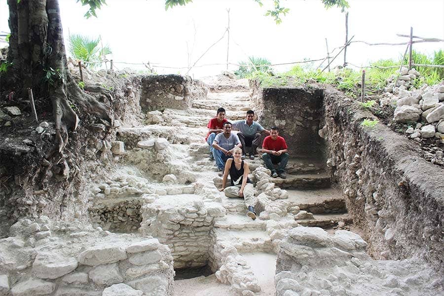 UTSA anthropology doctoral student Zoe Rawski sits with her excavation assistants on one of her own excavations at the ancient Maya archaeological site of Xunantunich in Belize.