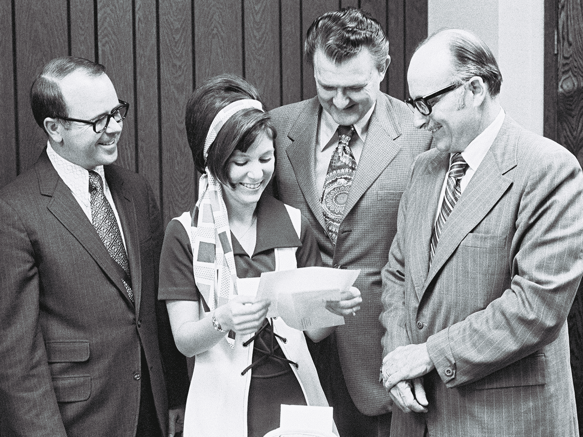 Accompanied by UTSA registrar Richard Lewis, UT System regent James Bauerle, and President Peter Flawn, Peggy Jo Tholen receives her acceptance letter to UTSA on March 30, 1973, making her the university’s first student.