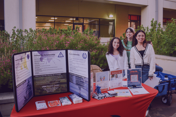 three students tabling for PEACE