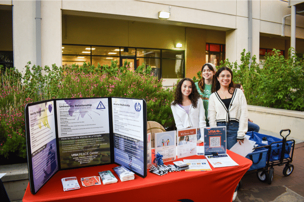 three female students tabling for PEACE