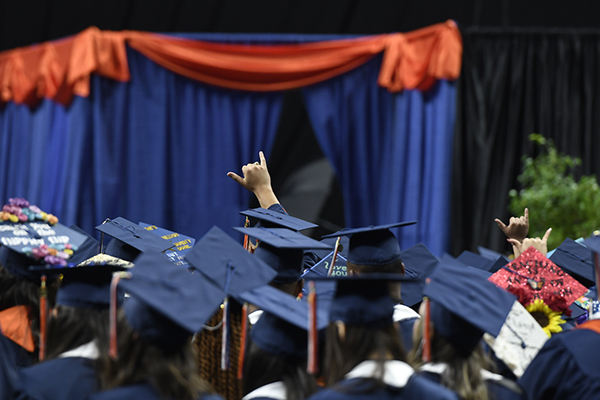 students singing alma mater at commencement