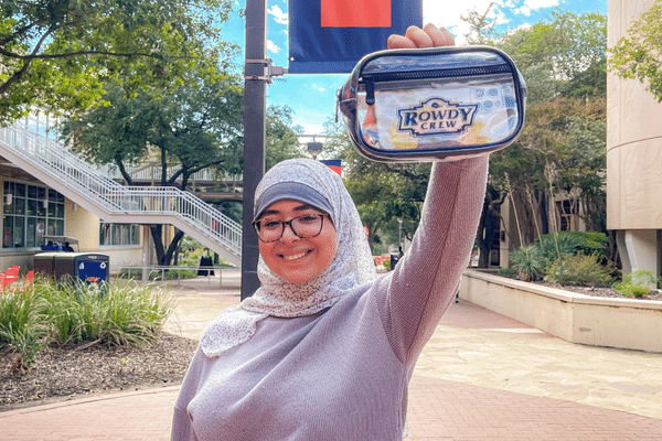 student holding Rowdy Crew clear bag