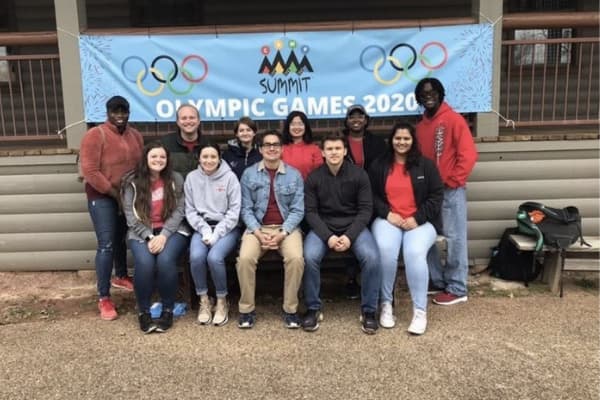 Group photo of students in front of an Olympic Games 2020 banner