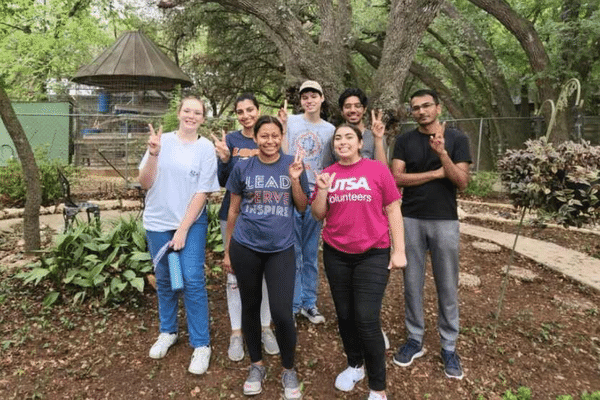 Group of students doing service outdoors