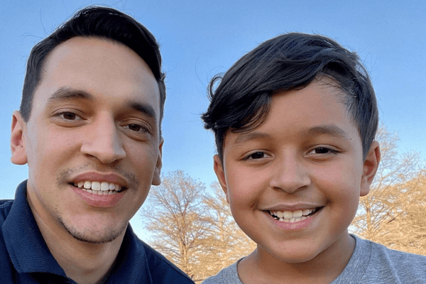 Two individuals smiling for the picture