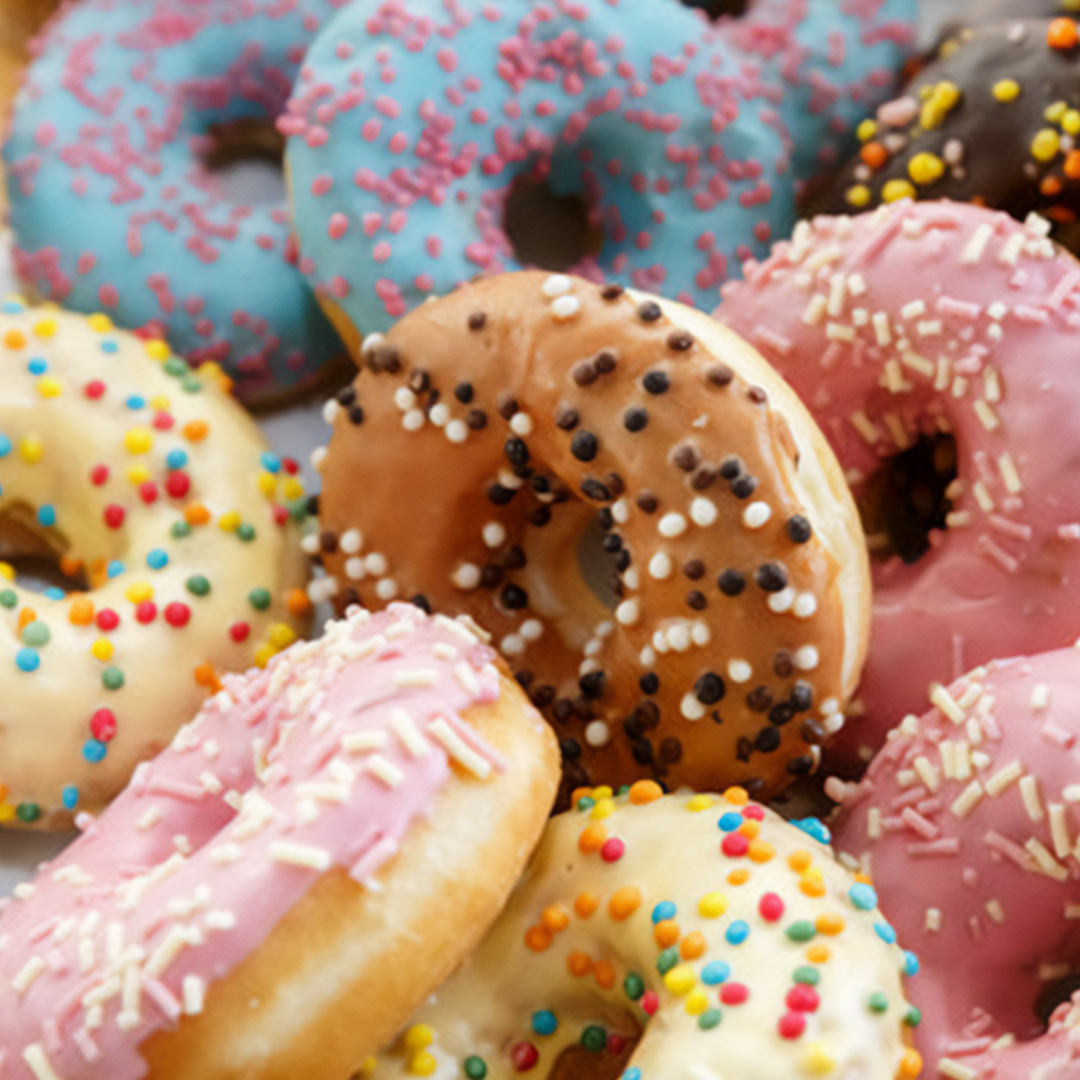 Donuts with colorful icing and sprinkles.