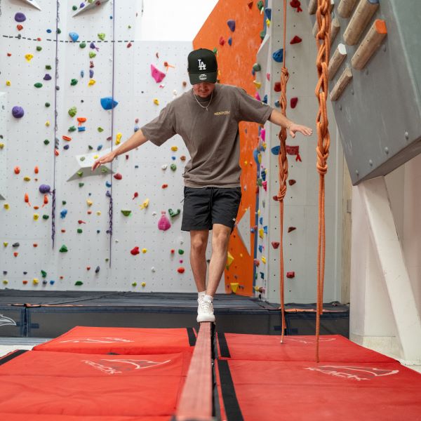 Student balances on the slackline.