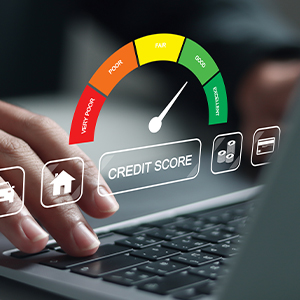Closeup of a hand typing on a laptop. A graphic of a credit score chart floats above the hand.