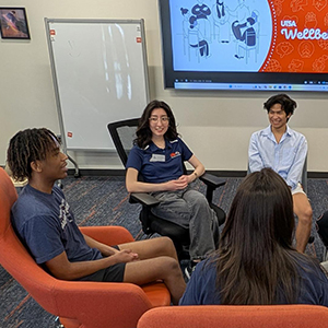 Students sitting in a circle talking to each other.