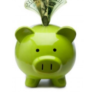 Bright green piggy bank with cash sticking out of the slit on its back