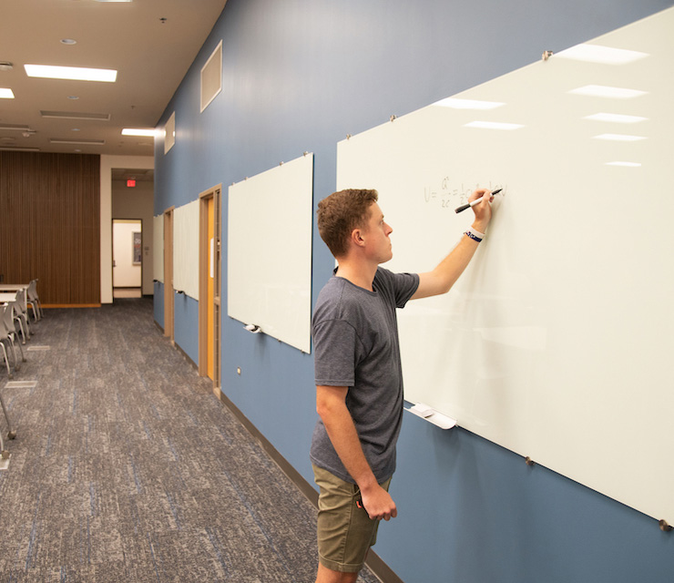 Student writing on a whiteboard