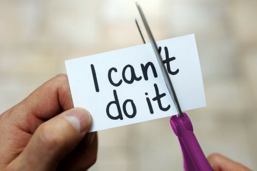 Paper with text 'I can't do it' being cut