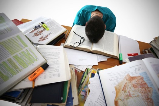 Student with head on books