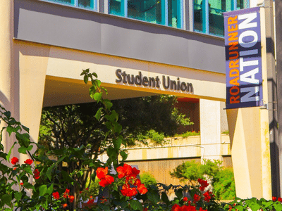 red flowers in front of Student Union entrance