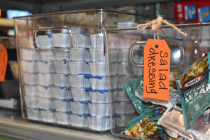 Bin with packets of salad dressing.