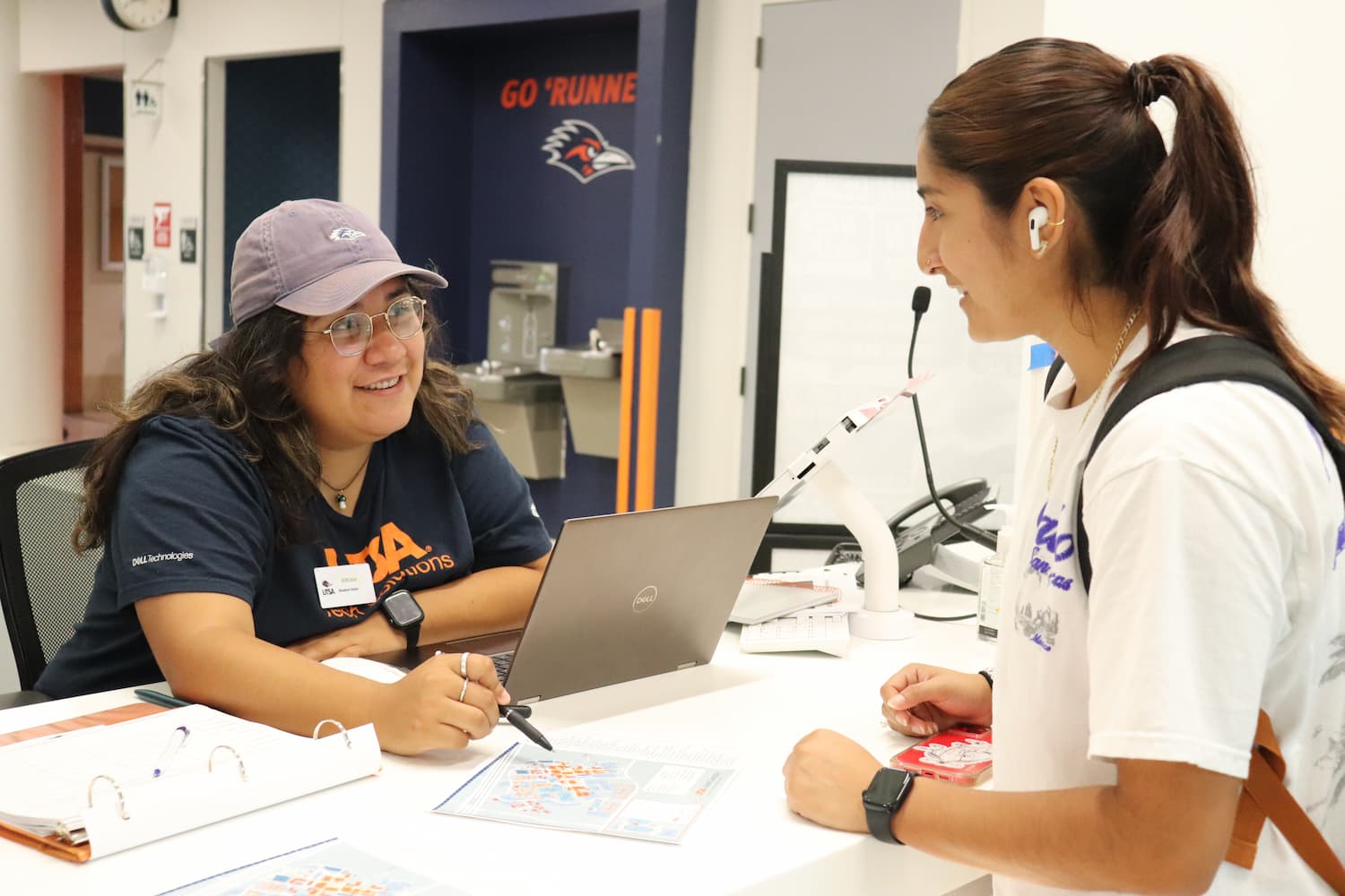 info desk giving directions to a student